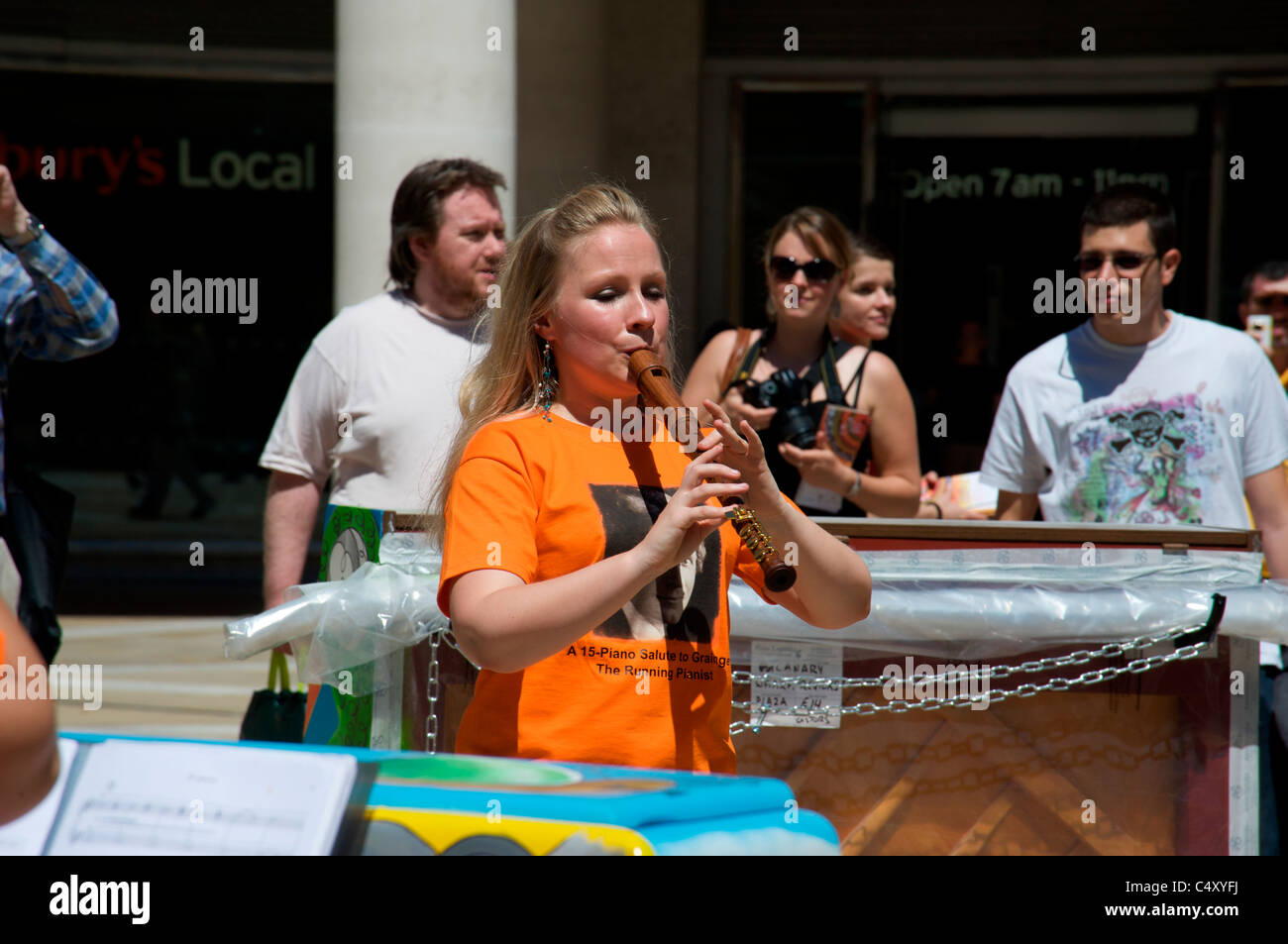 Woman plays the flute at an outdoor concert during the City of London Festival 2011 Stock Photo