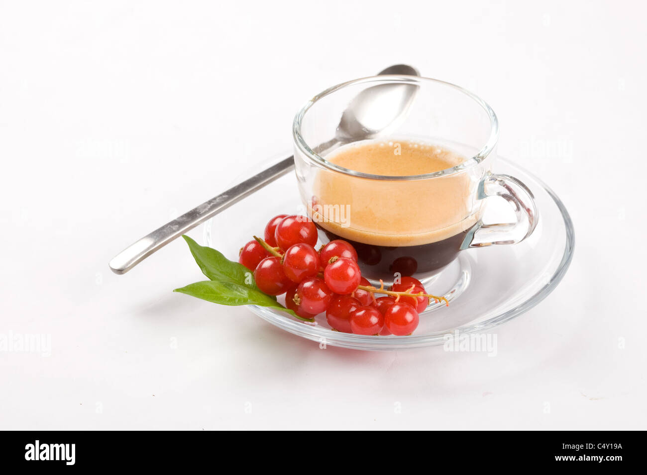 photo of espresso with currant in glass cup on white isolated background Stock Photo