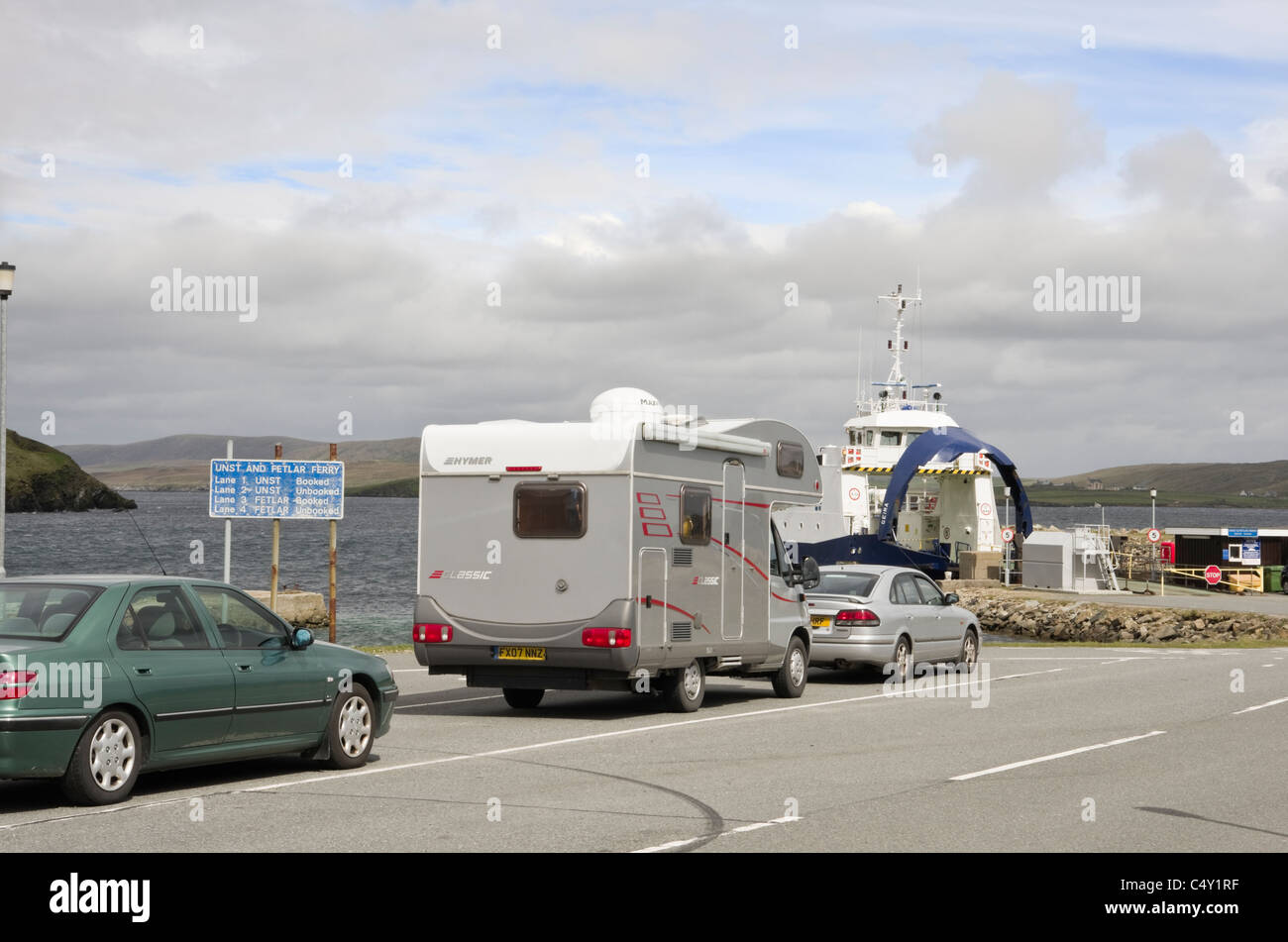 Gutcher, Yell, Shetland Islands, Scotland, UK. Car Ferry terminal with car and motorhome queuing for Unst across Bluemull Sound Stock Photo