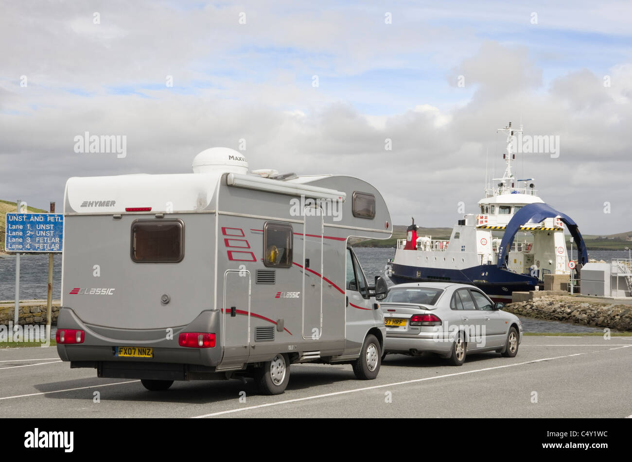 Car Ferry terminal with car and motorhome queuing for Unst across Bluemull Sound. Gutcher, Yell, Shetland Islands, Scotland, UK Stock Photo