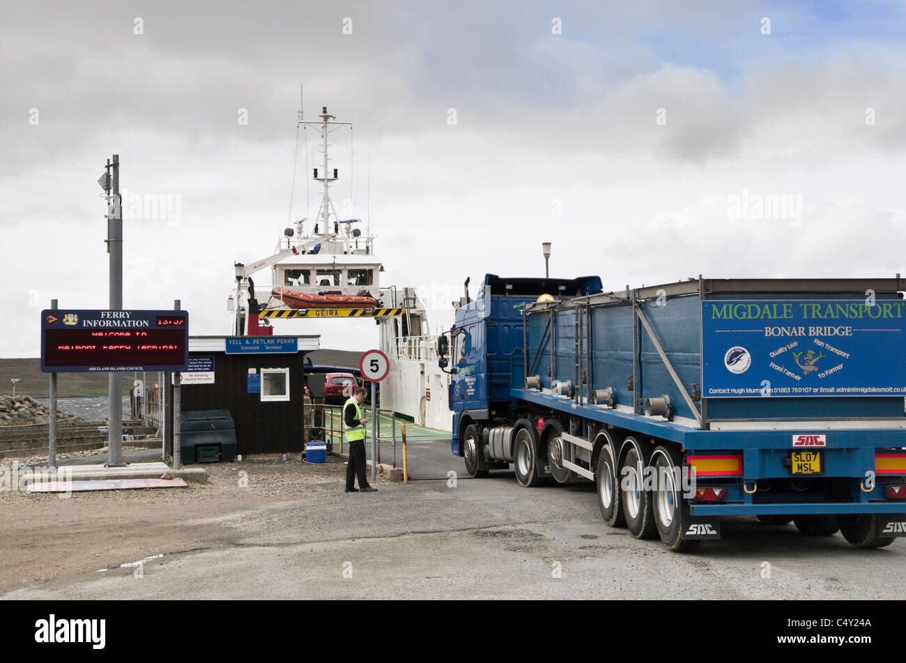 Ferry terminal with a lorry boarding boat to Yell island across Bluemull Sound. Belmont, Unst, Shetland Islands, Scotland, UK Stock Photo