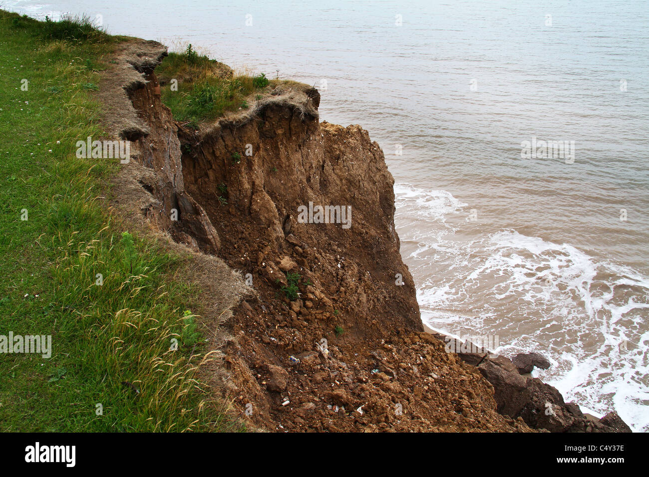 Erosion of soft clay cliff on east coast of Yorkshire in the UK. Stock Photo