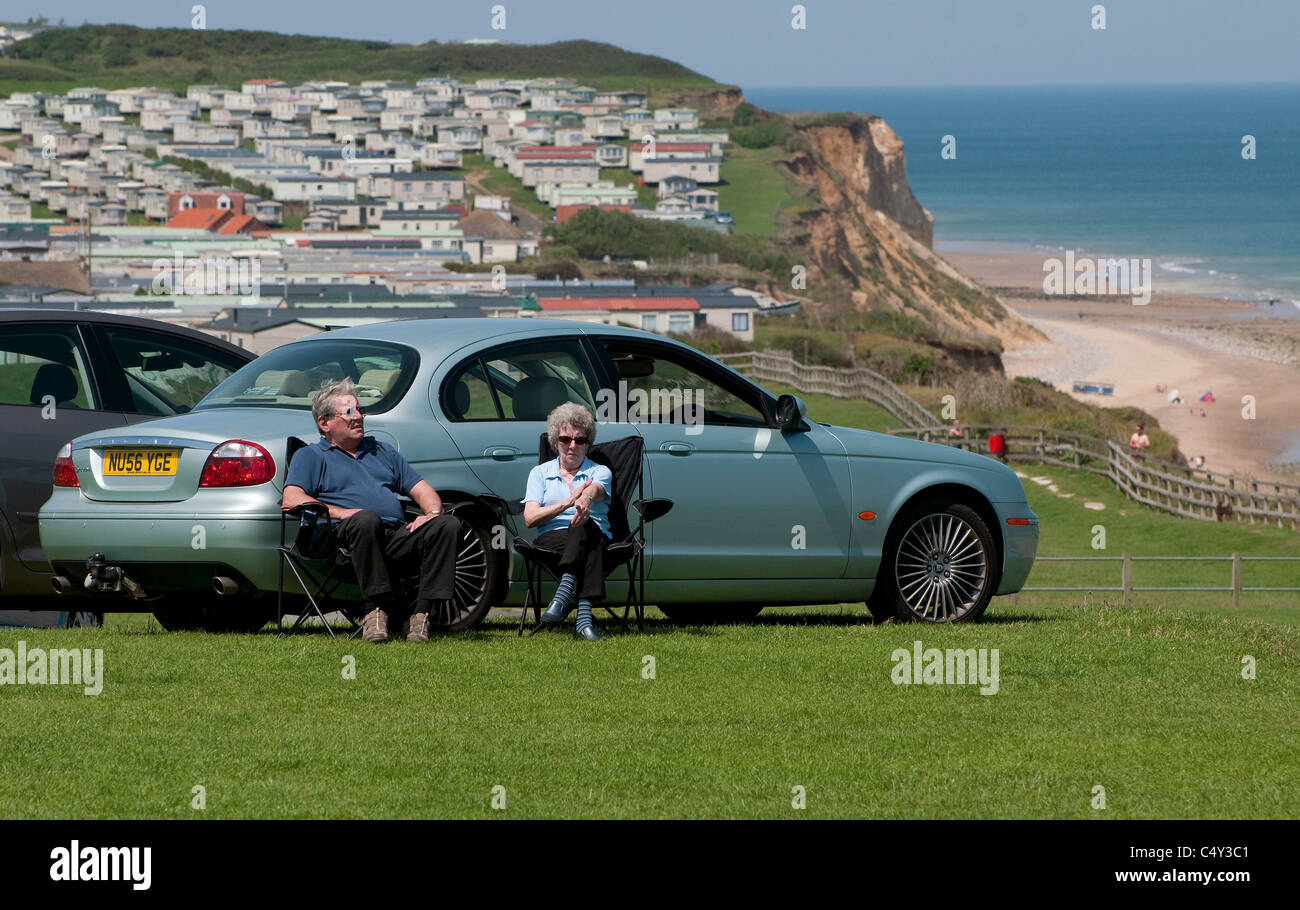 senior couple sitting in car park, cromer, norfolk, england Stock Photo