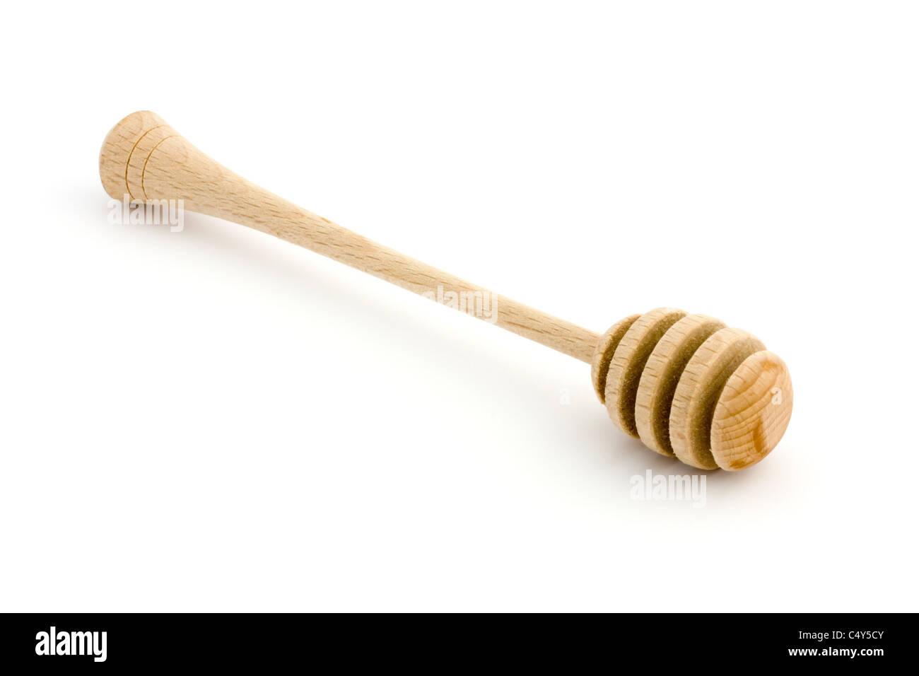 Wooden honey drizzler isolated on white Stock Photo
