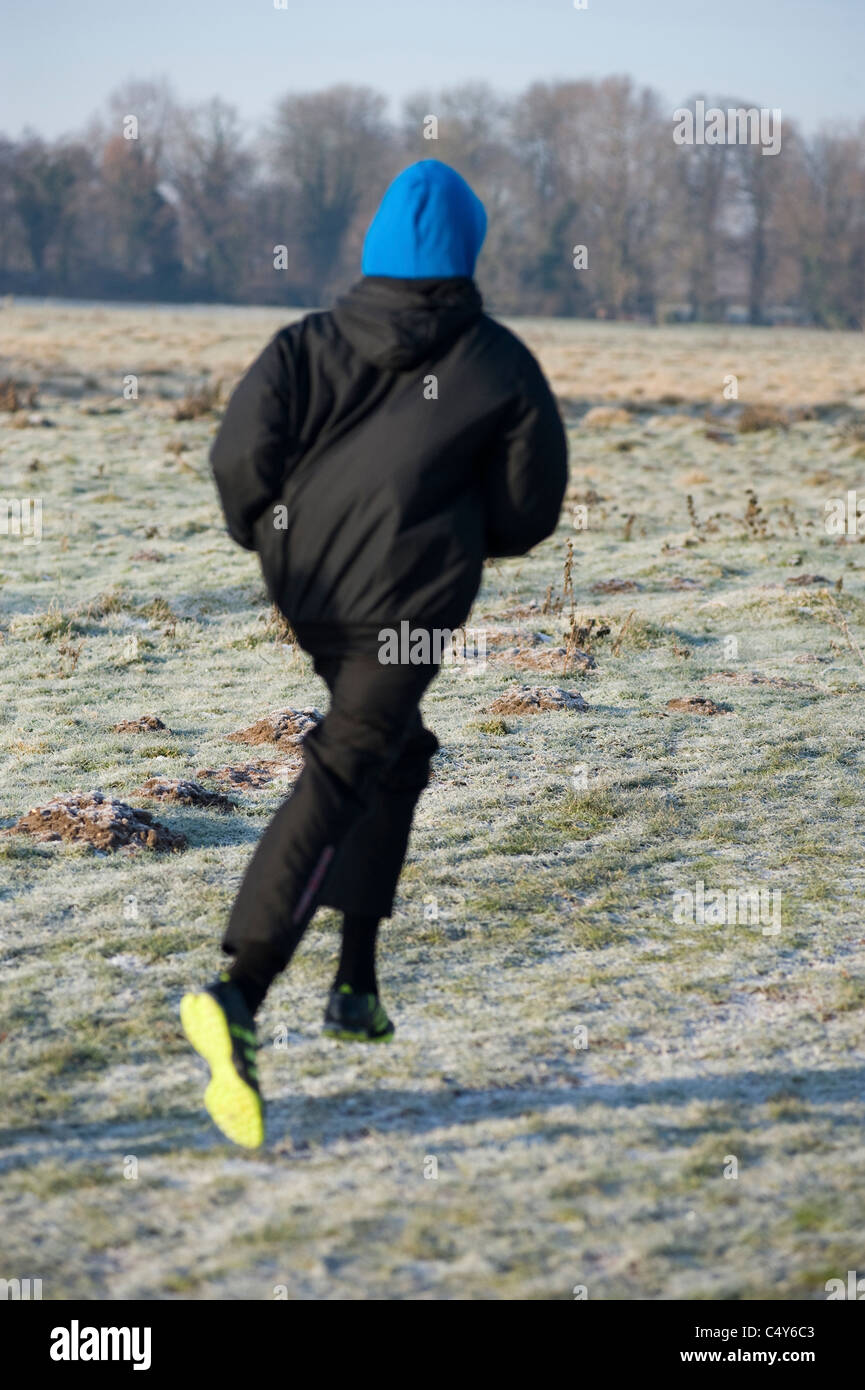 young man running on frosty morning Stock Photo