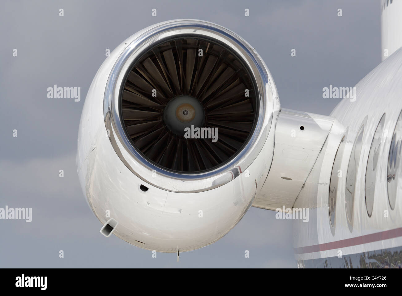 Closeup of a turbofan jet engine on a private jet aircraft. No proprietary details visible. Stock Photo
