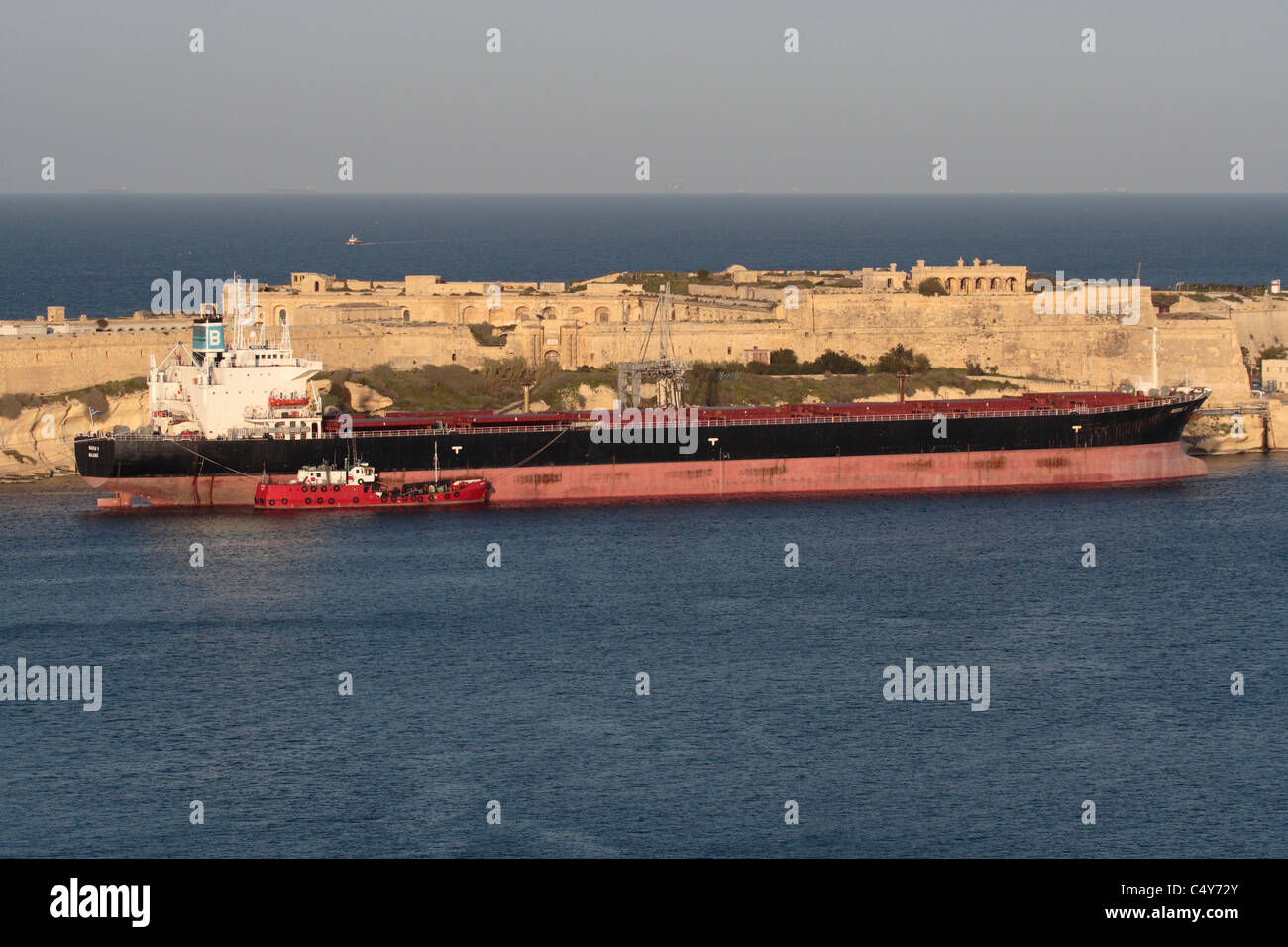 The cargo vessel Maria V moored in Malta's Grand Harbour and taking on fuel from a bunkering vessel tied up alongside Stock Photo