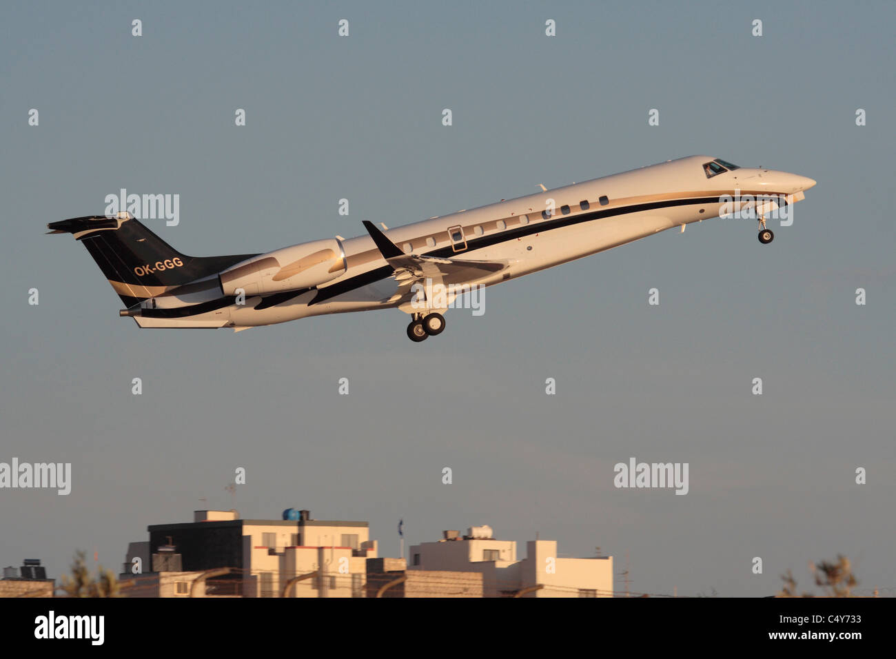 Embraer Legacy 600 business jet aircraft taking off at sunset Stock Photo