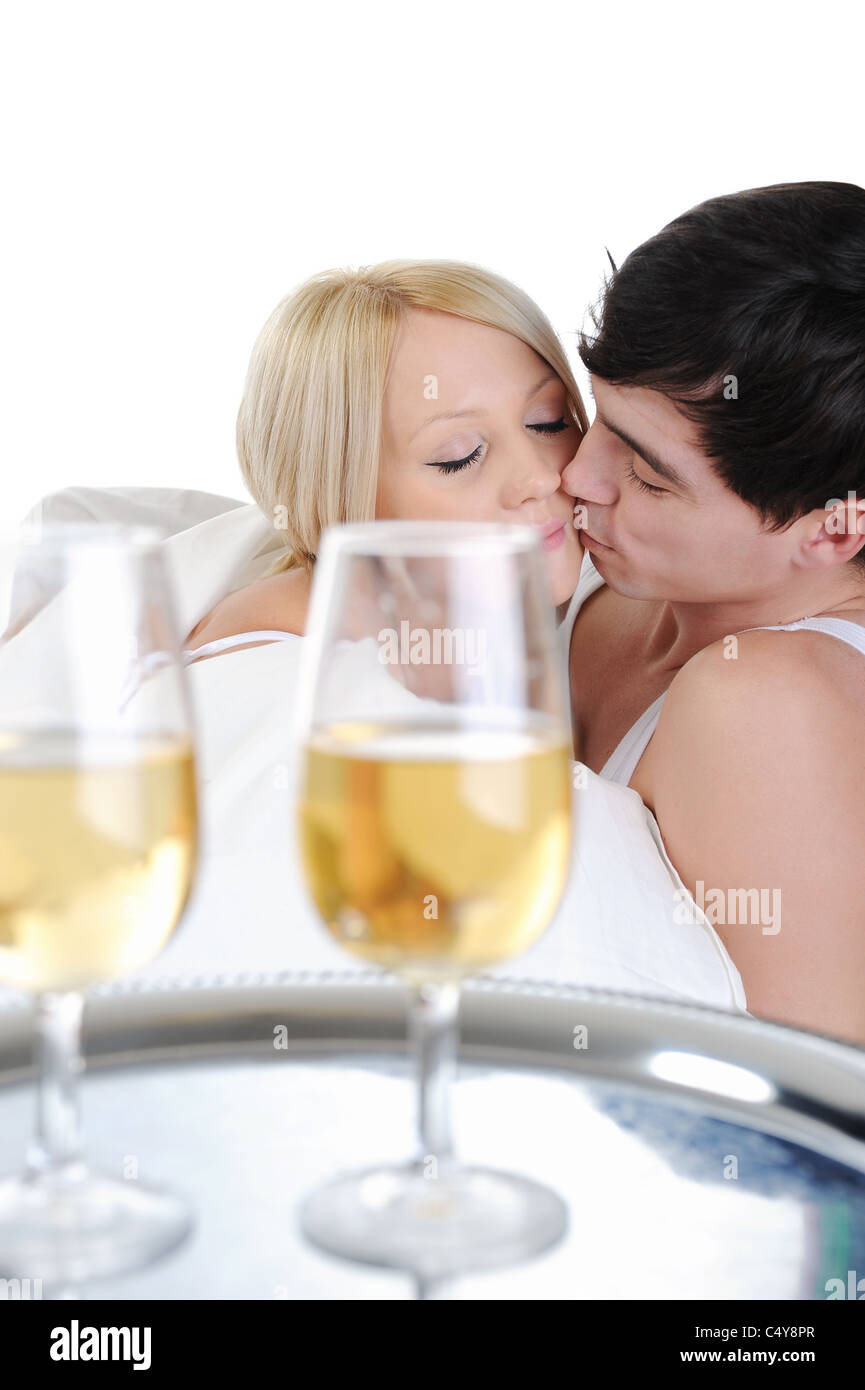 Young couple drinking champagne in bed Stock Photo