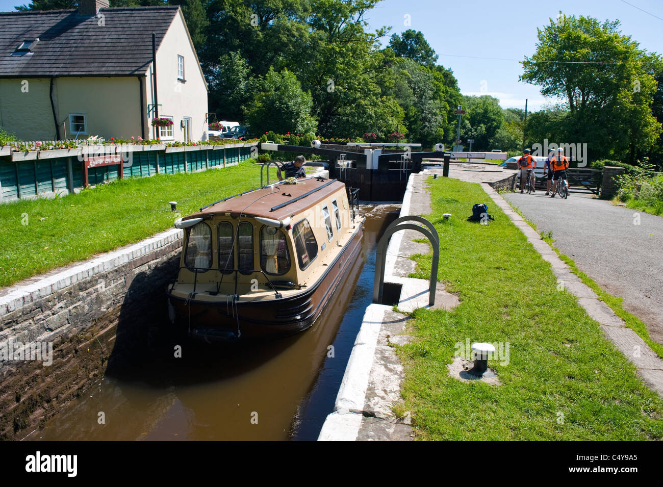 Small narrowboat going through lock on canal near Brecon Powys South Wales UK Stock Photo