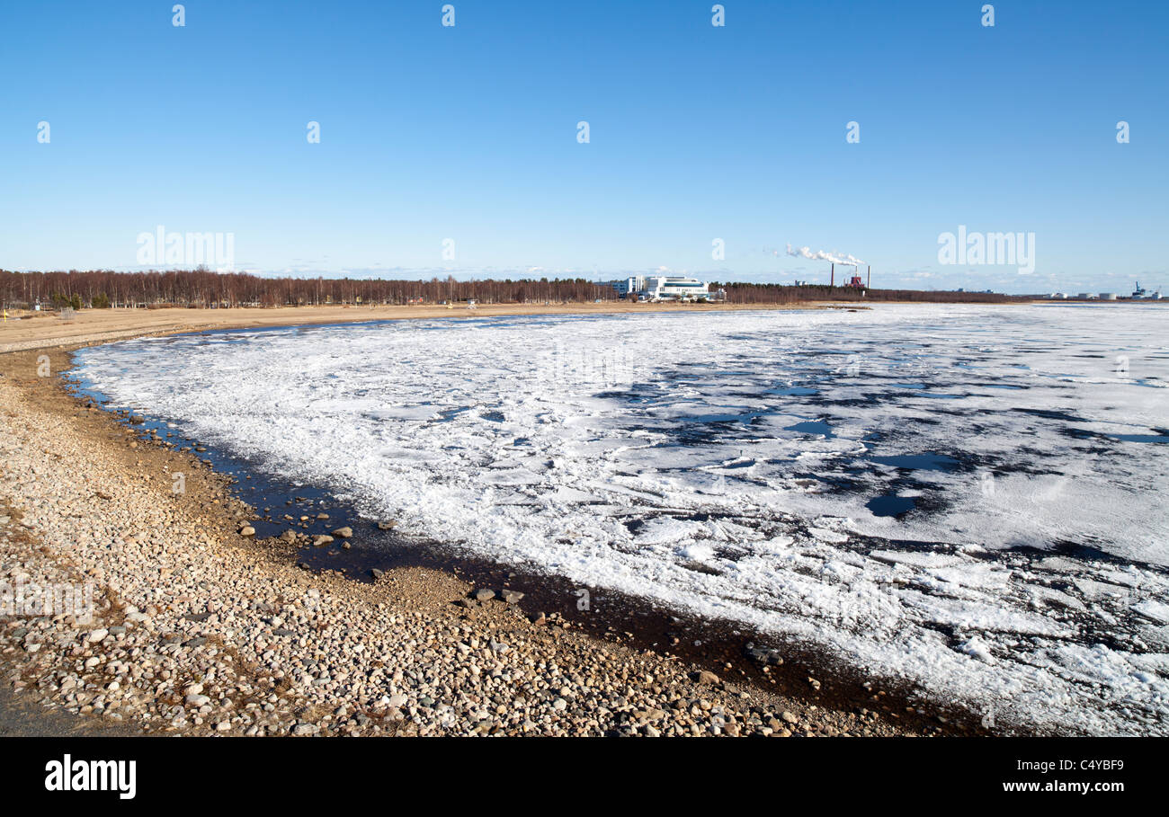 Blocks of melting sea ice float to the shore , Nallikari beach , Oulu Bothnian Bay , Baltic Sea , Finland Stock Photo
