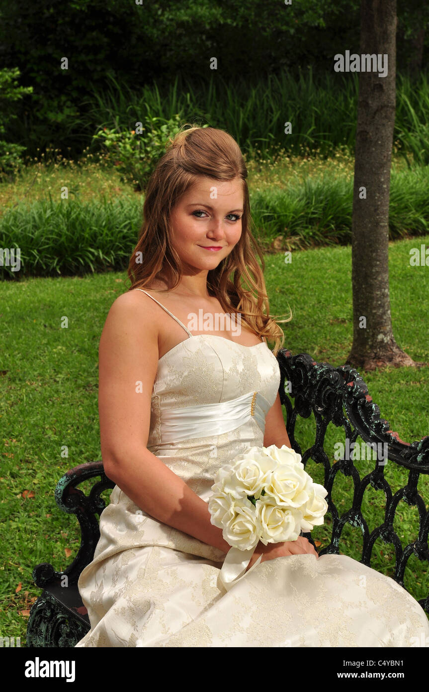 A pretty Caucasian bride sits out doors Stock Photo