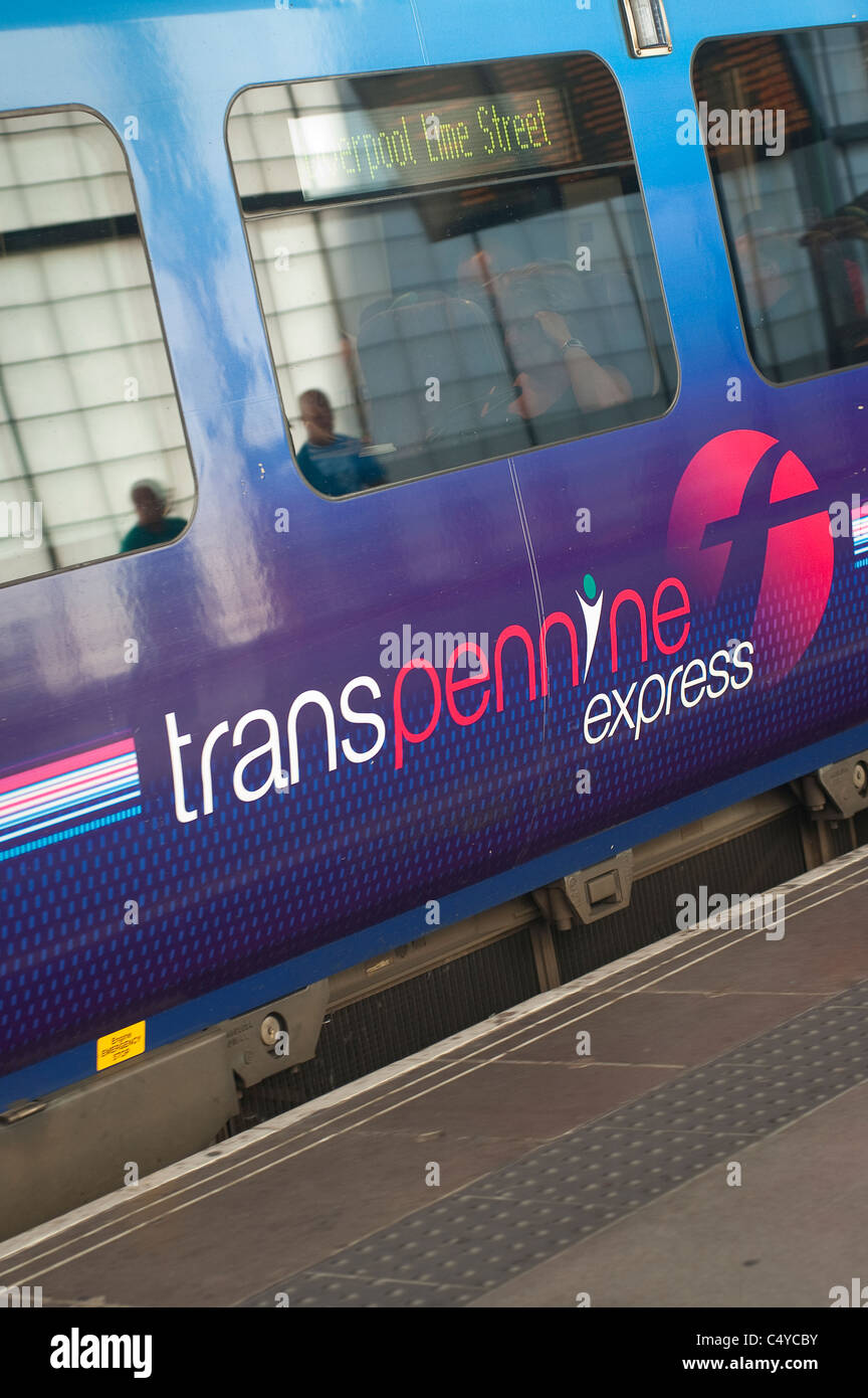 Transpennine Express train waiting at a railway station in England. Stock Photo