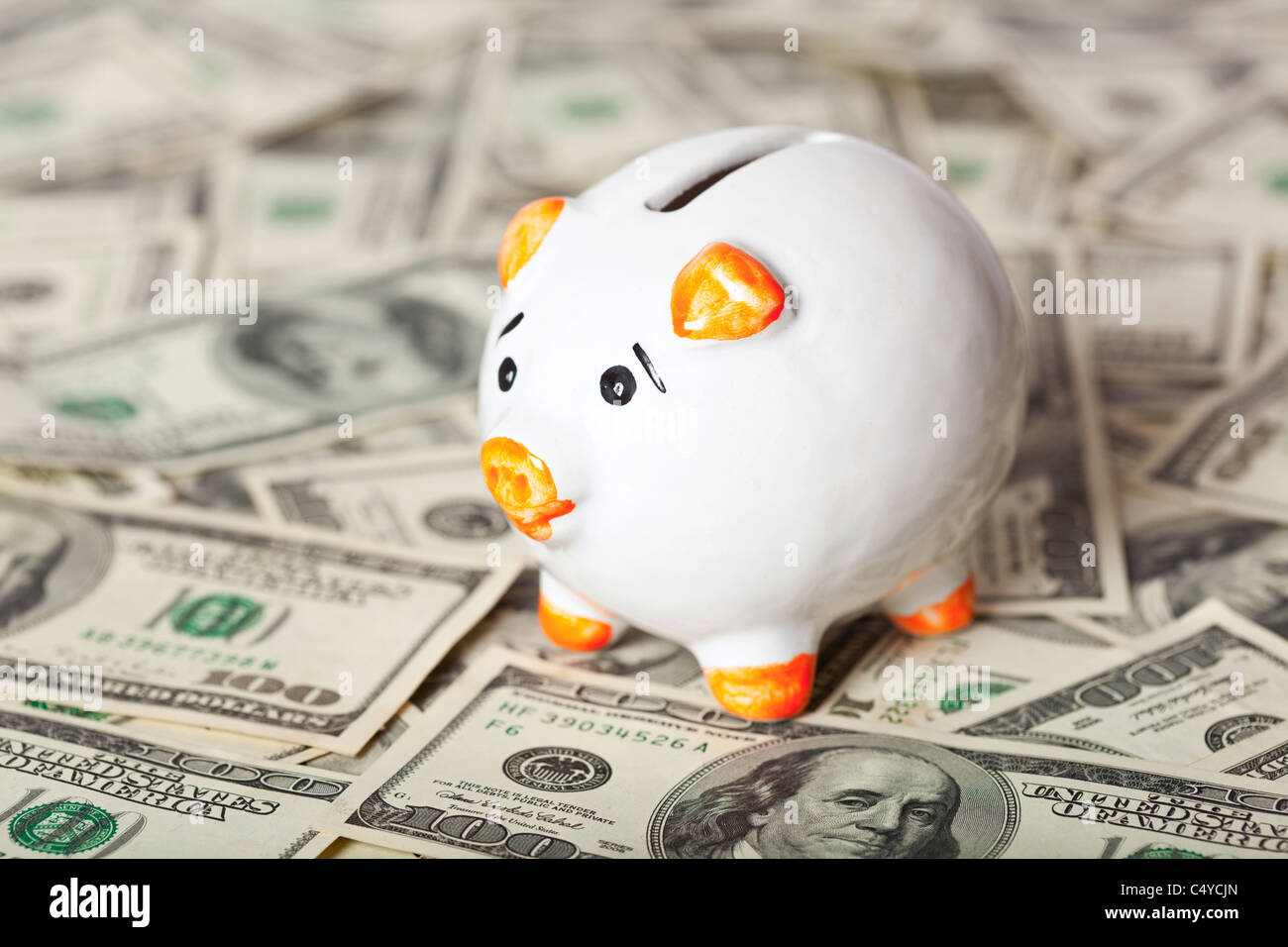 Piggy bank on dollars background Stock Photo