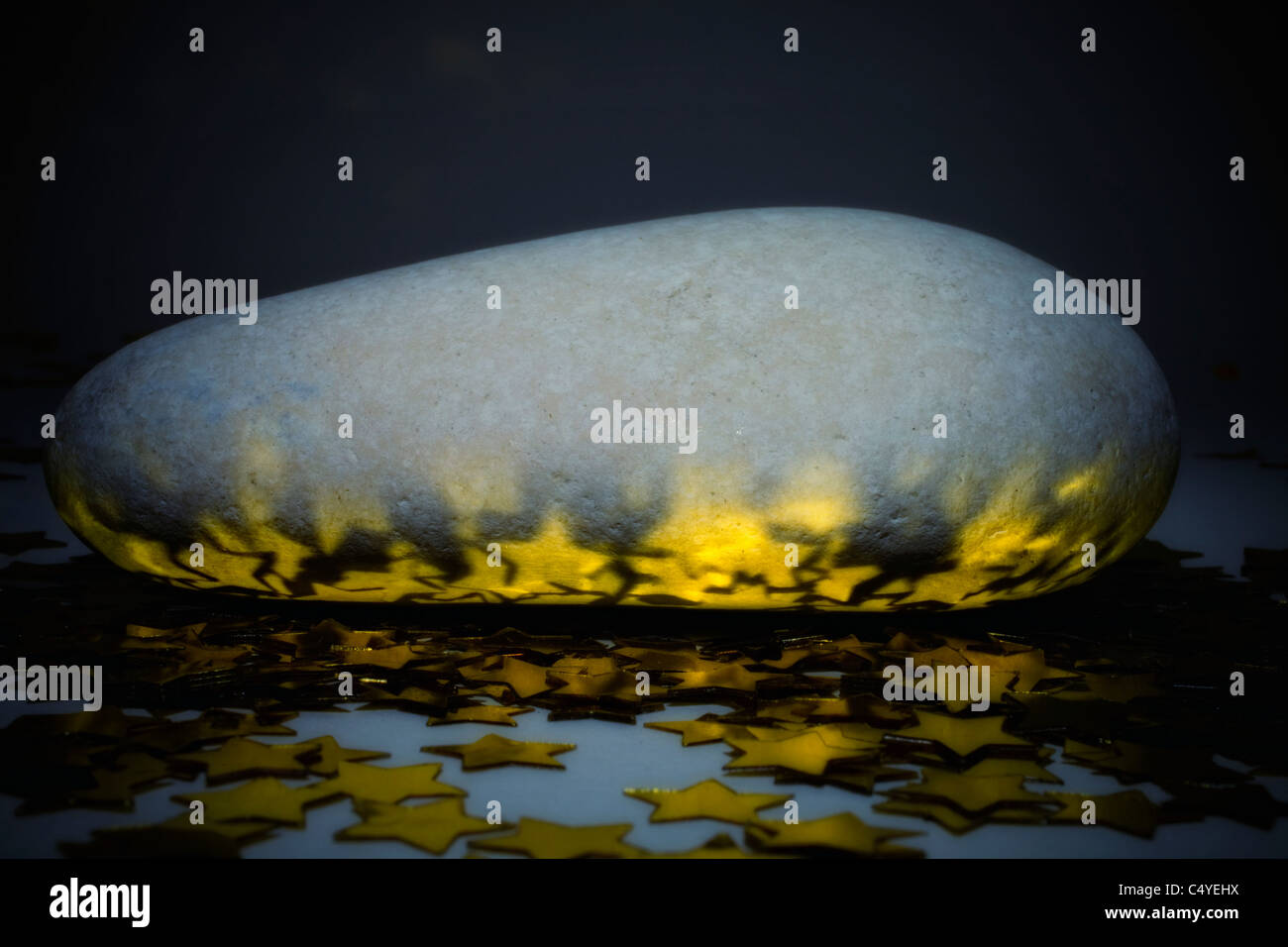 oval stone with golden stars closeup Stock Photo