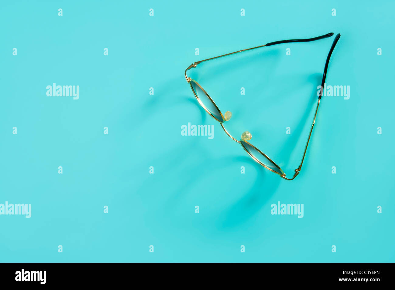 doctor glasses with soft shadow over green desk background Stock Photo