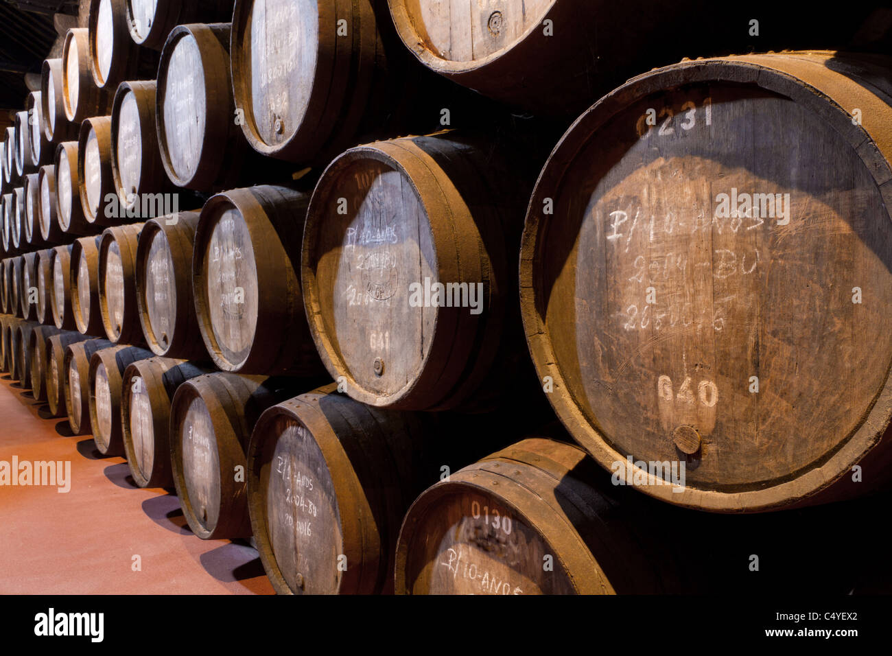 wooden barrels hold Port fortified wine to mature in wine cellars in Villa Nova de Gaia, Portugal Stock Photo
