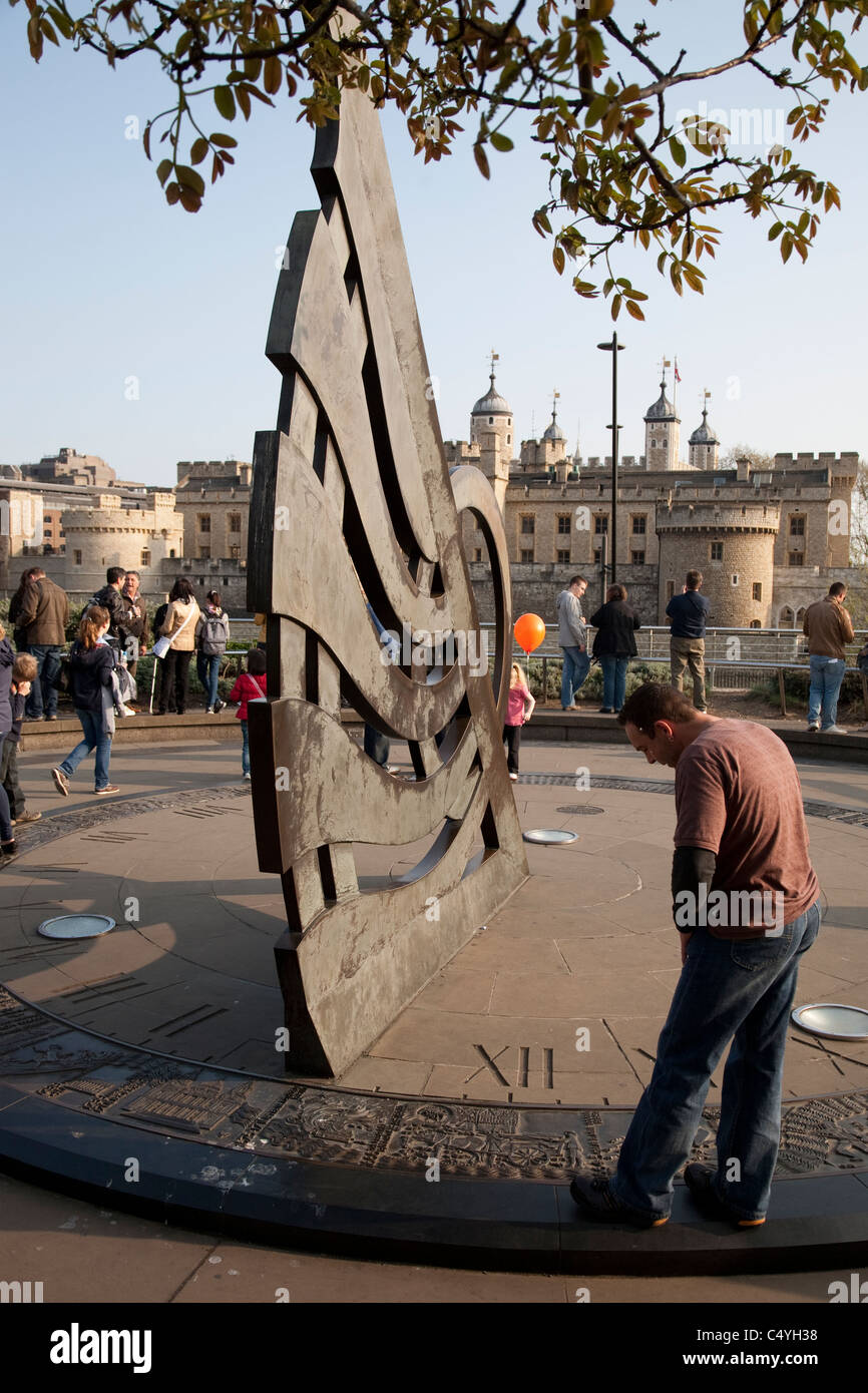 Sundial at Tower Hill Underground Station with the Tower of London in the background, London