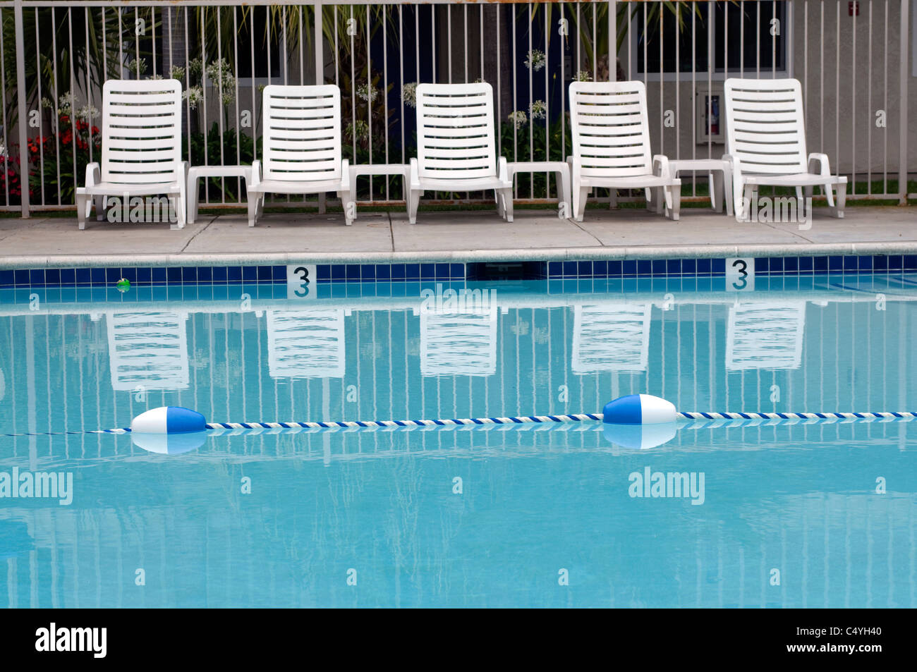 reclining lounge chairs at swimming pool Stock Photo