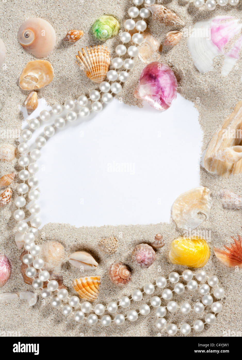 frame composition over beach sand beach with blank paper with pearls