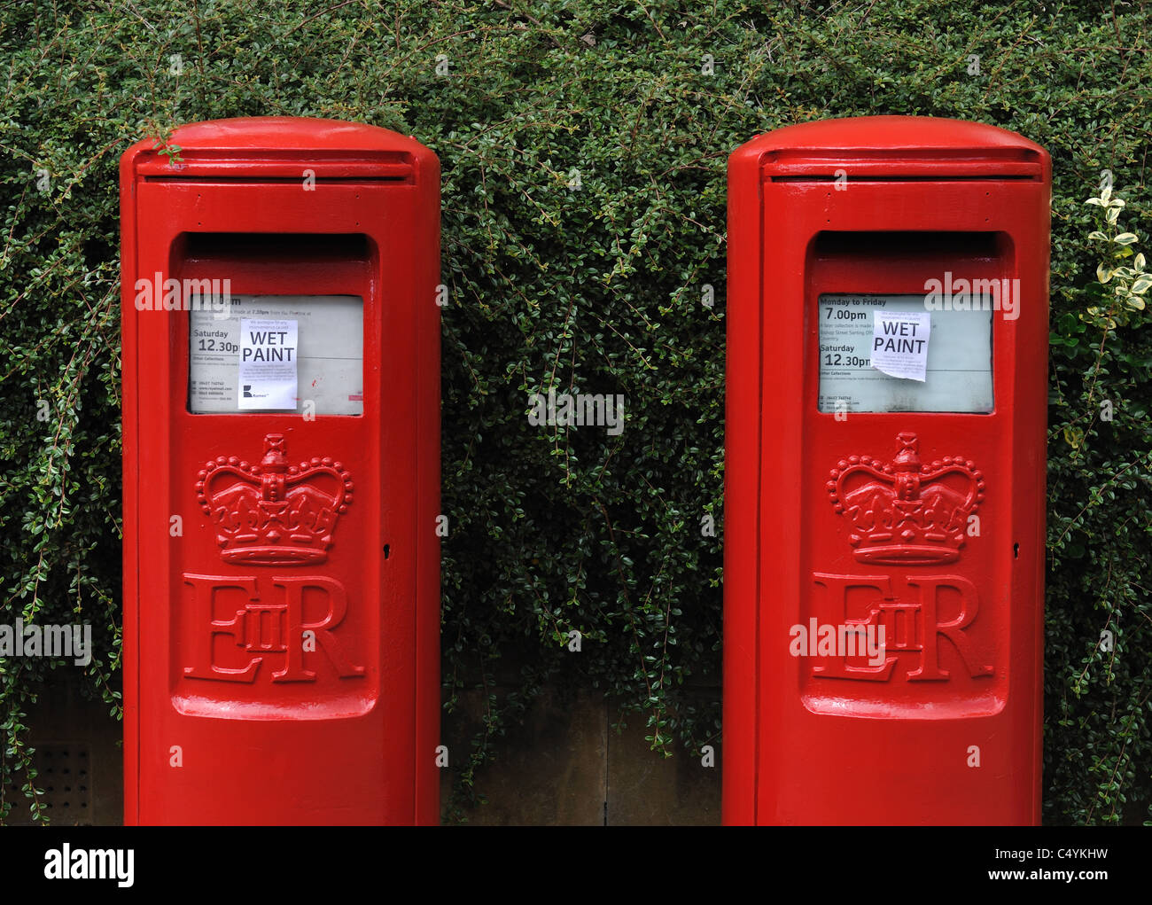 Freshly painted type K post boxes with wet paint signs Stock Photo