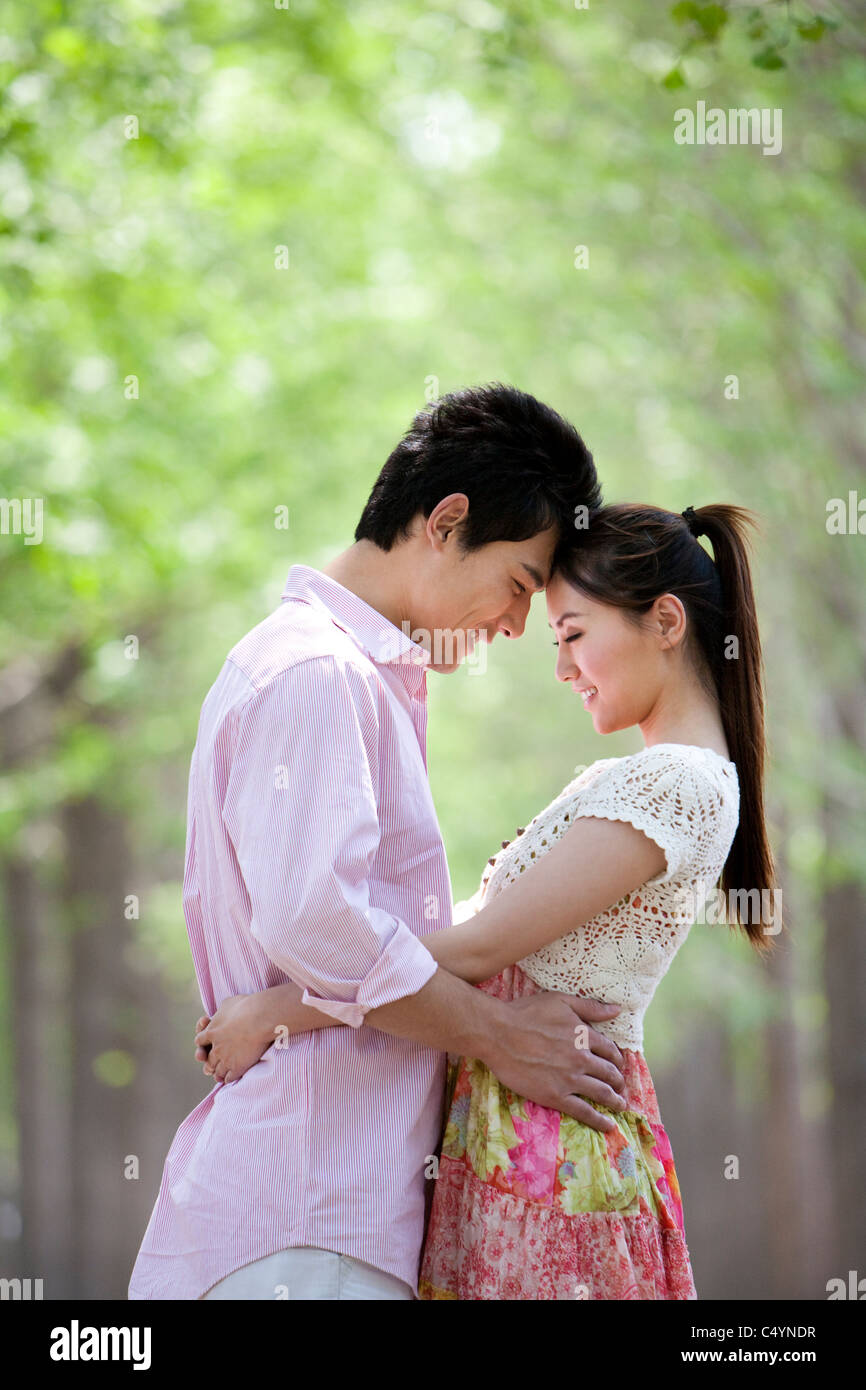 Happy Young Couple Embracing at the Park Stock Photo - Alamy