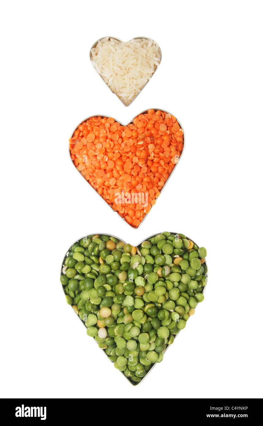 Rice, lentils and dried split peas in heart shaped frames Stock Photo