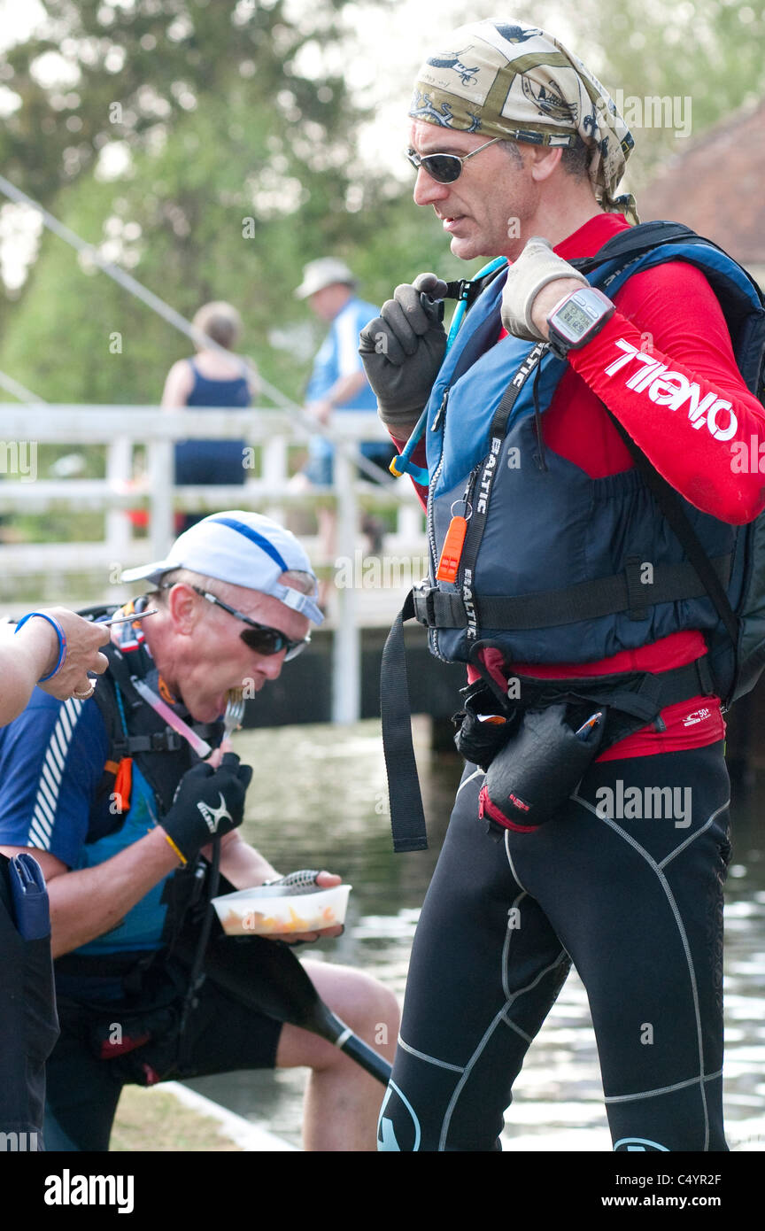 A two-man canoe team stop to eat at Newbury lock during the grueling annual Devizes to Westminster International Canoe Race Stock Photo