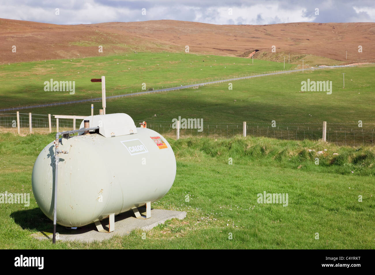 Domestic Calor gas tank outdoors in remote country location. Shetland Islands, Scotland, UK, Britain. Stock Photo