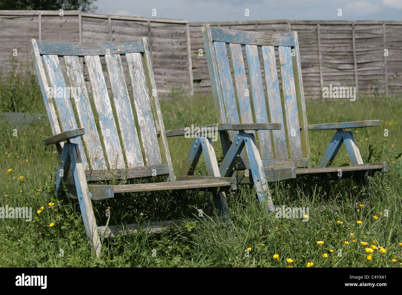 Two wooden deck chairs in an English country garden Stock Photo - Alamy