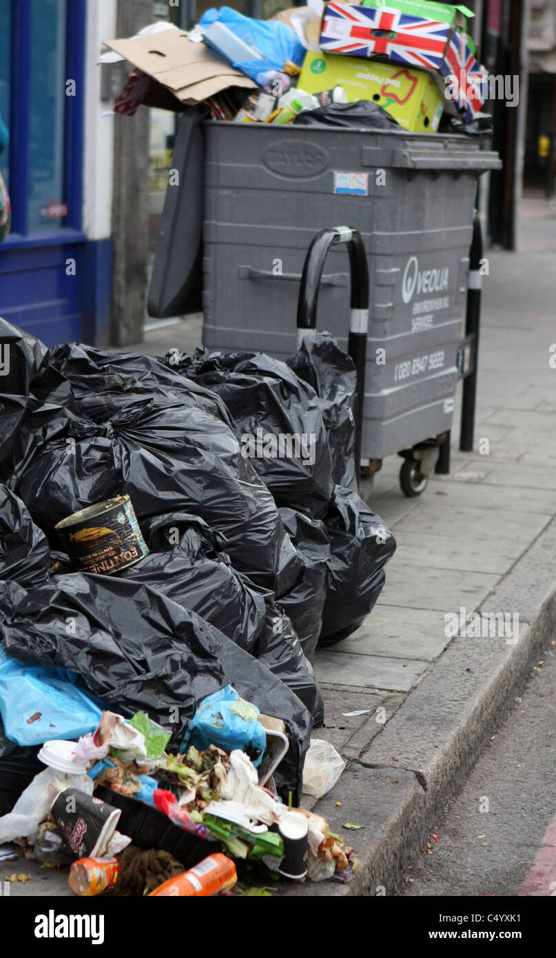 Rubbish in wheelie bin and in black sacks in a street in London Stock ...