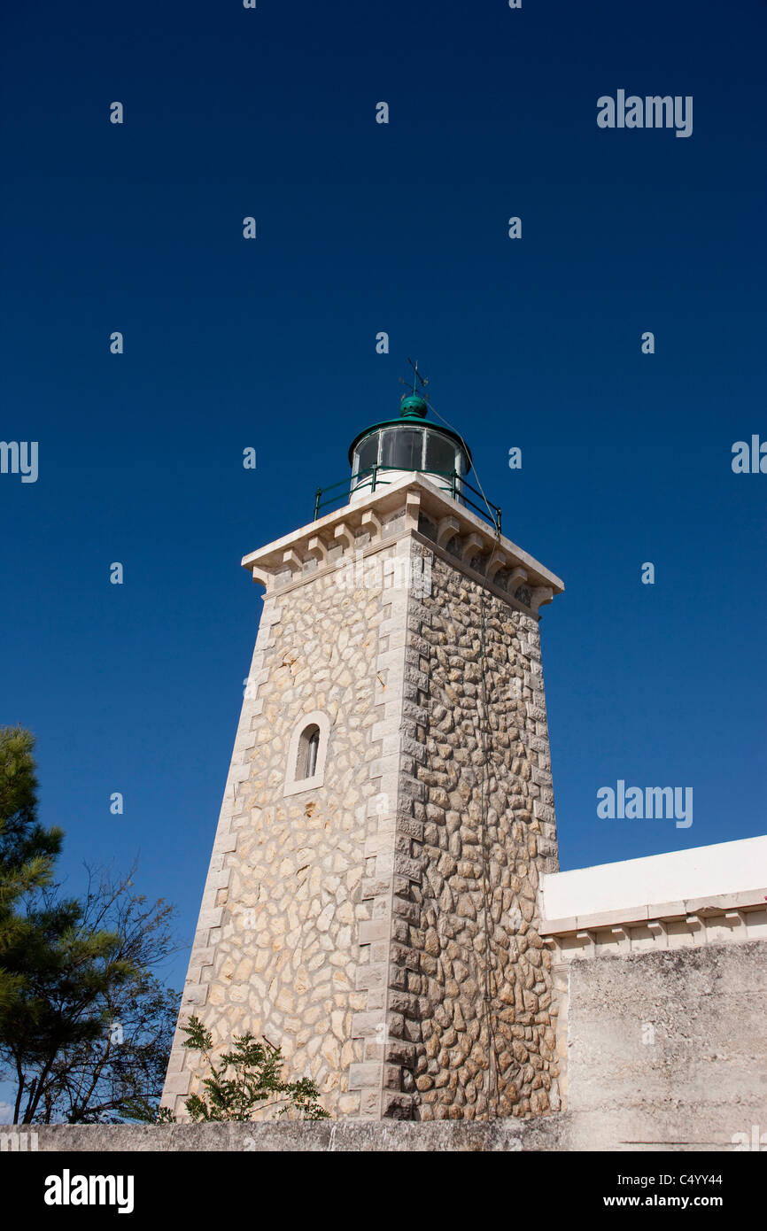 The lighthouse which warns of the headland near Lakka. Paxos, Greece. Stock Photo