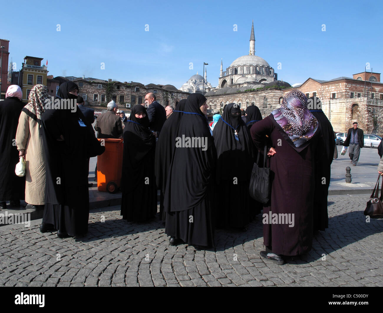 Turkey Istanbul Sultanahmet old town Turkish Muslim islamic women with traditional black Burka Chador visiting Istanbul mosque Stock Photo