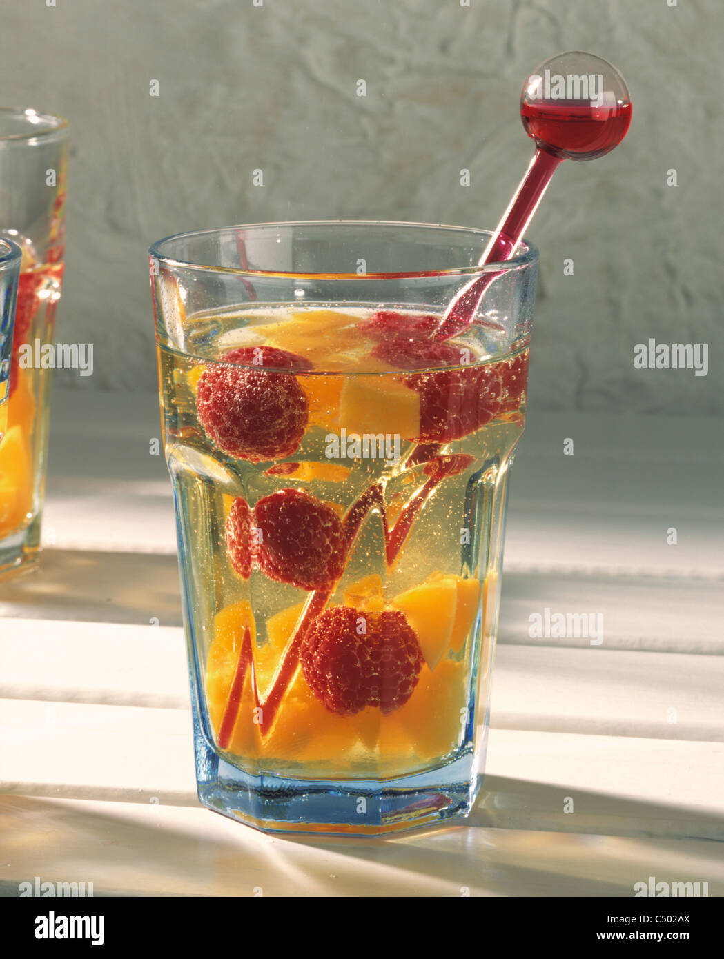 Apple spritzer with raspberries and peaches Stock Photo Alamy