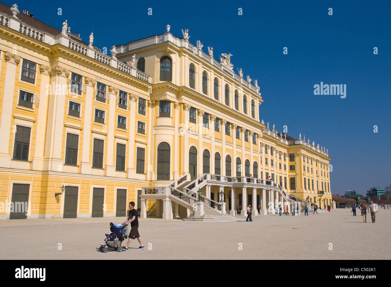 Man pushing pram outside Schloss Schönbrunn palace Vienna Austria central Europe Stock Photo
