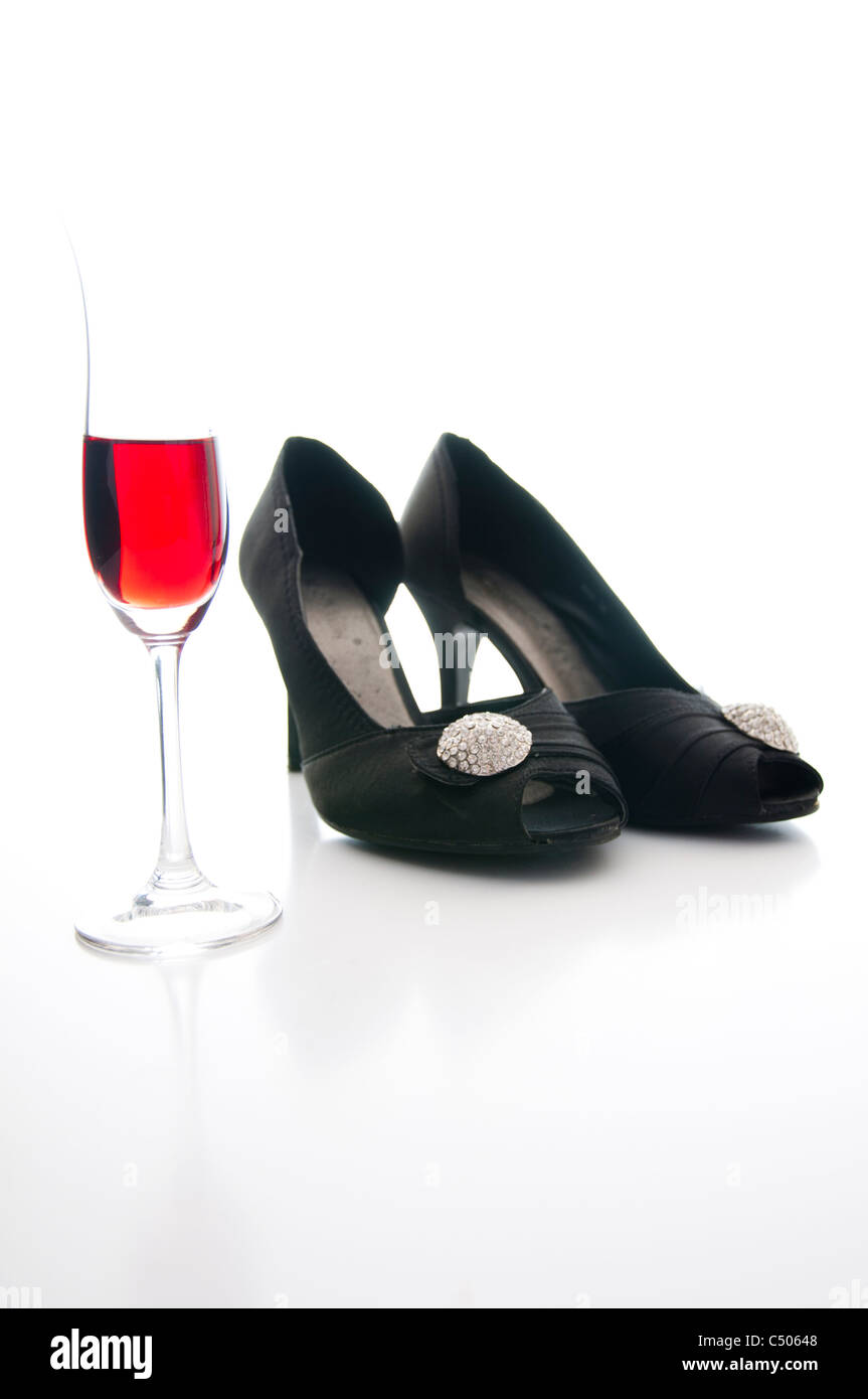 red wine and black shoes on white background Stock Photo