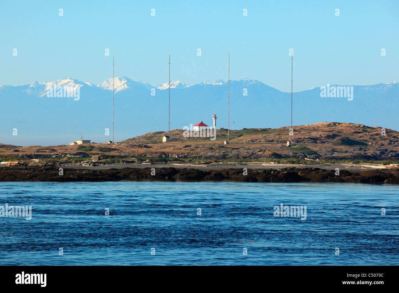View of Trial island lighthouse  juan de fuca strait near Victoria BC Canada. Olympic mountain range backdrop Stock Photo