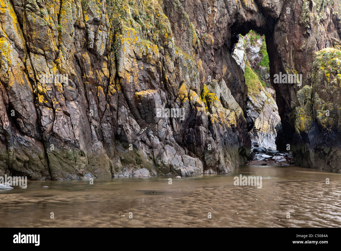 A view of a natural rock arch at the beach on the Solway Firth Scotland Stock Photo