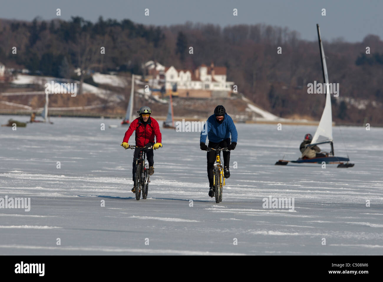Bicyclists on a frozen Navesink River in Red Bank, New Jersey Stock Photo