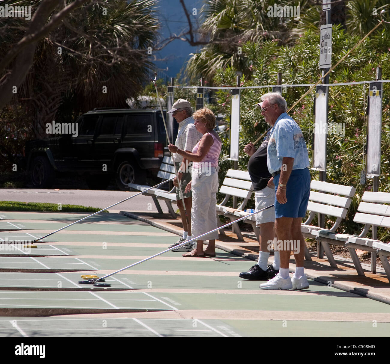 Seniors playing shuffleboard Stock Photo - Alamy