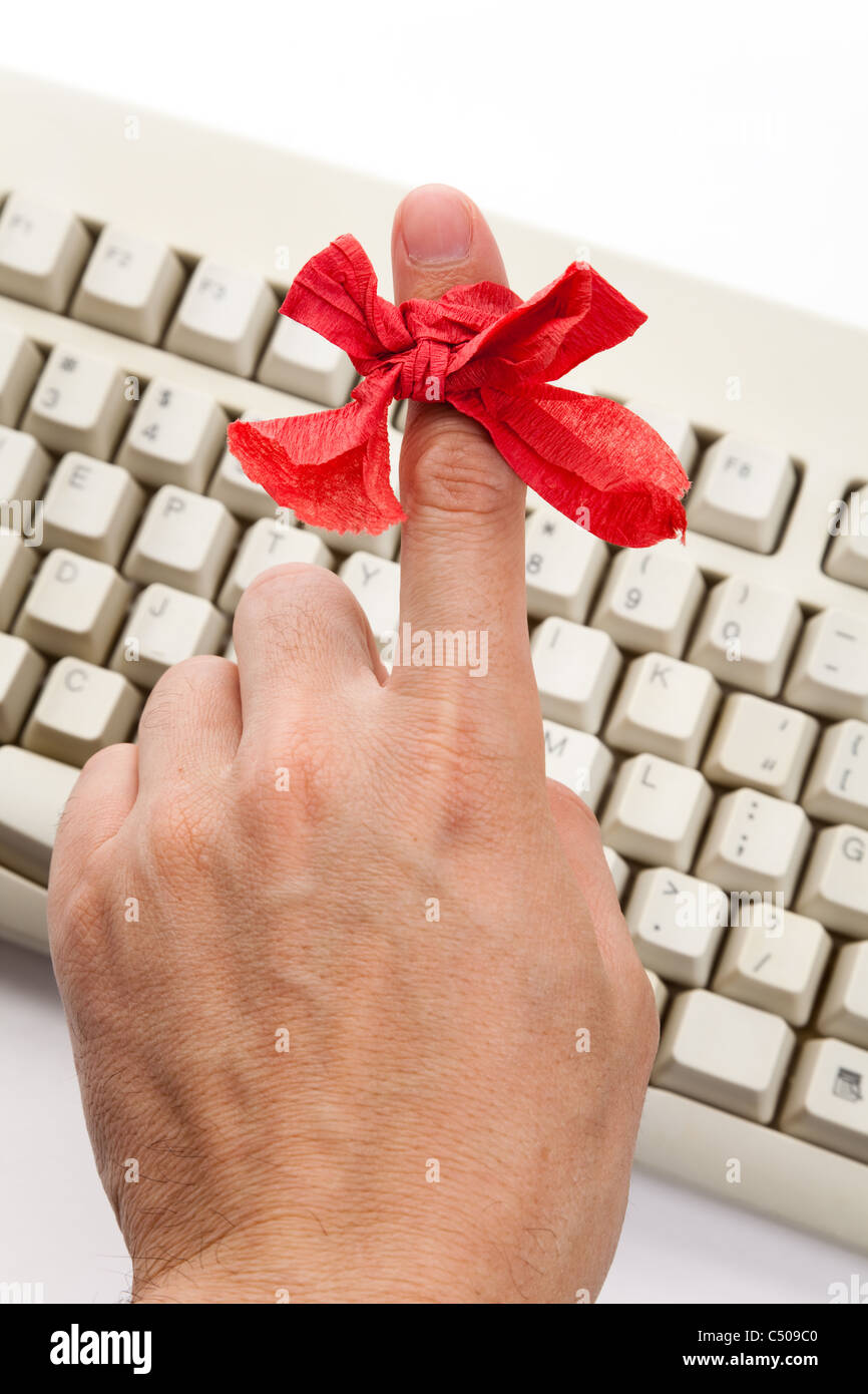 Red bow on finger and computer keyboard Stock Photo - Alamy