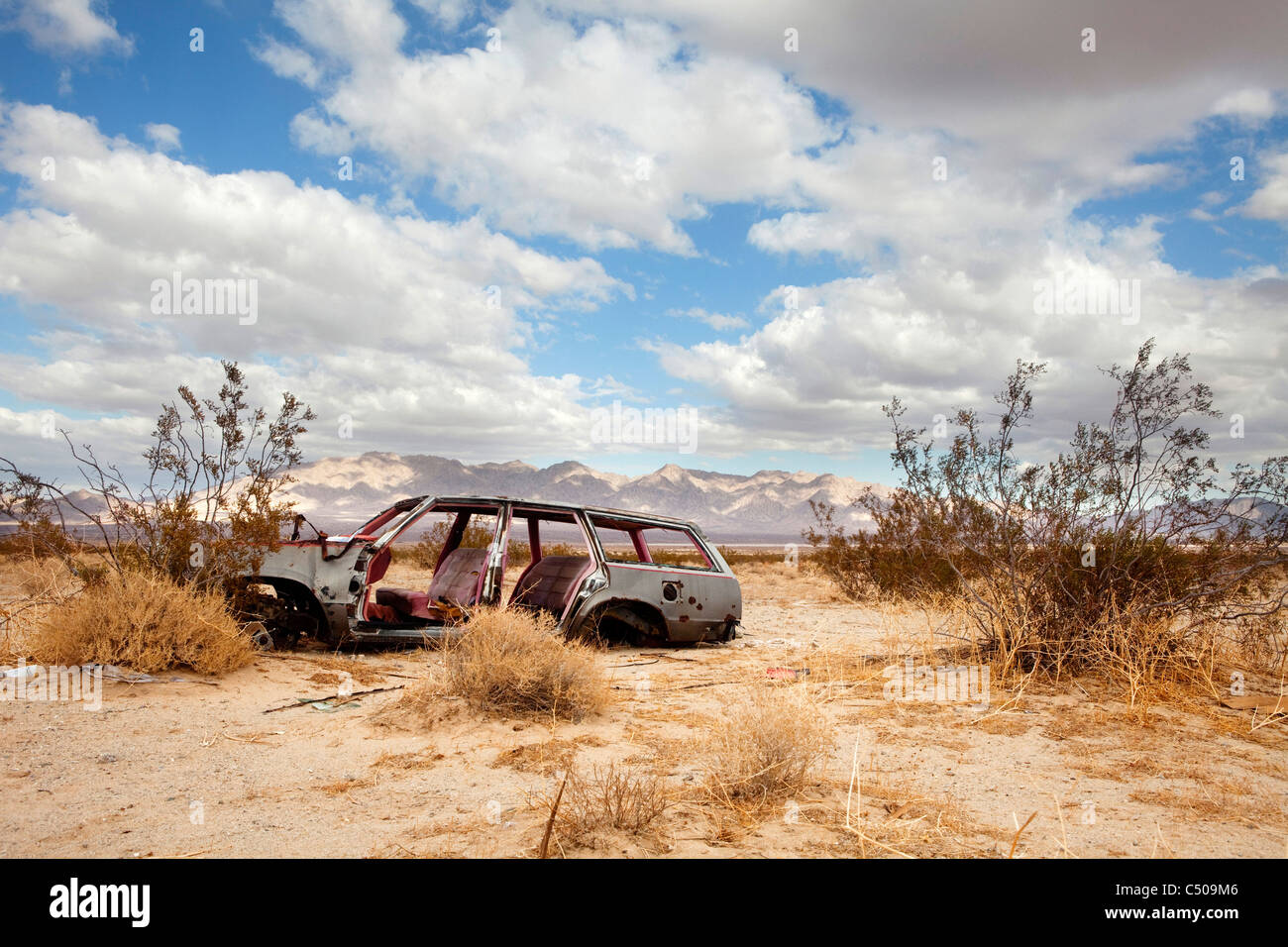 Wrecked car in barren area Stock Photo