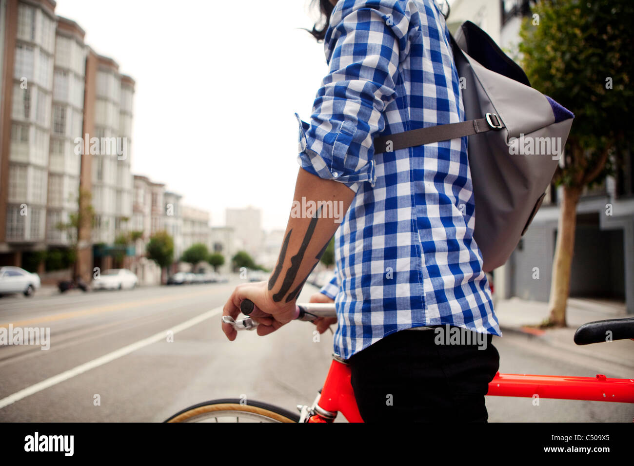 Vietnamese bicycle messenger on city street Stock Photo
