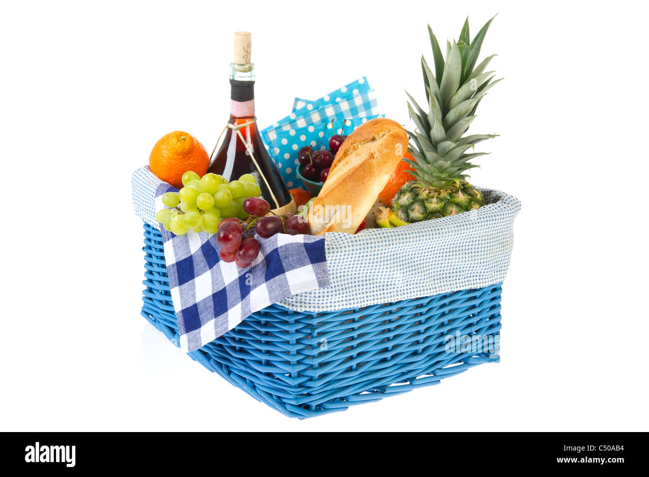 Picnic basket with bread fresh fruit and wine Stock Photo