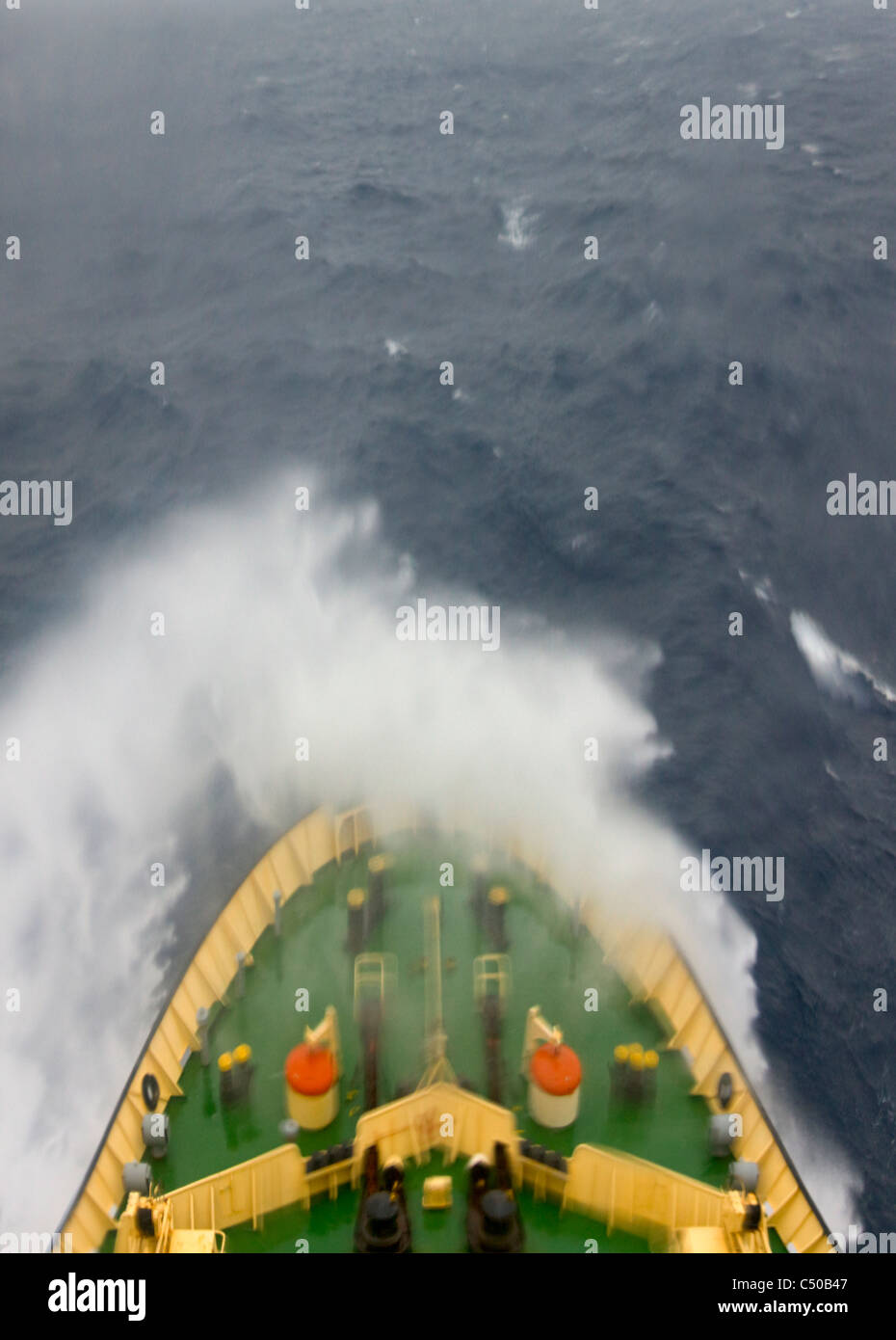 Ship navigating in the ocean through rough water, Antarctica Stock Photo