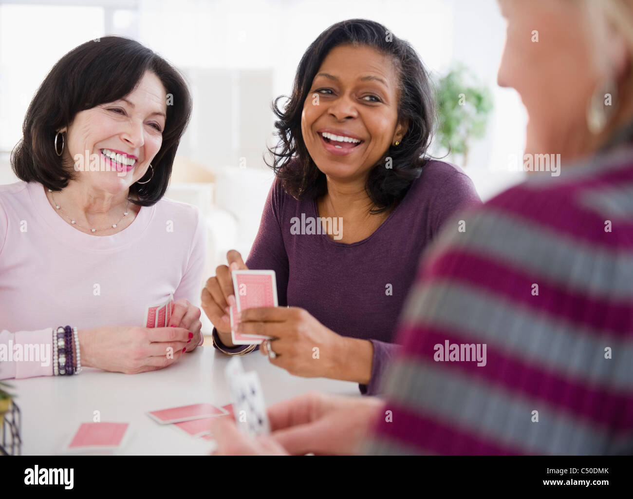 Friends playing cards together Stock Photo - Alamy