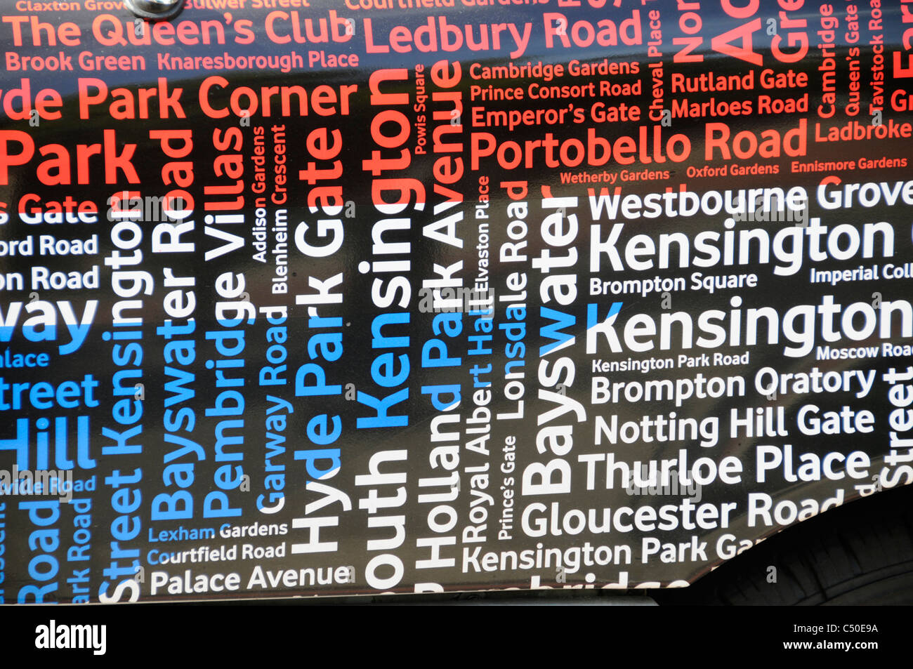 Abstract formed by close up tag word cloud of location place & street names used as background for Vodafone advertising on London taxi cab England UK Stock Photo