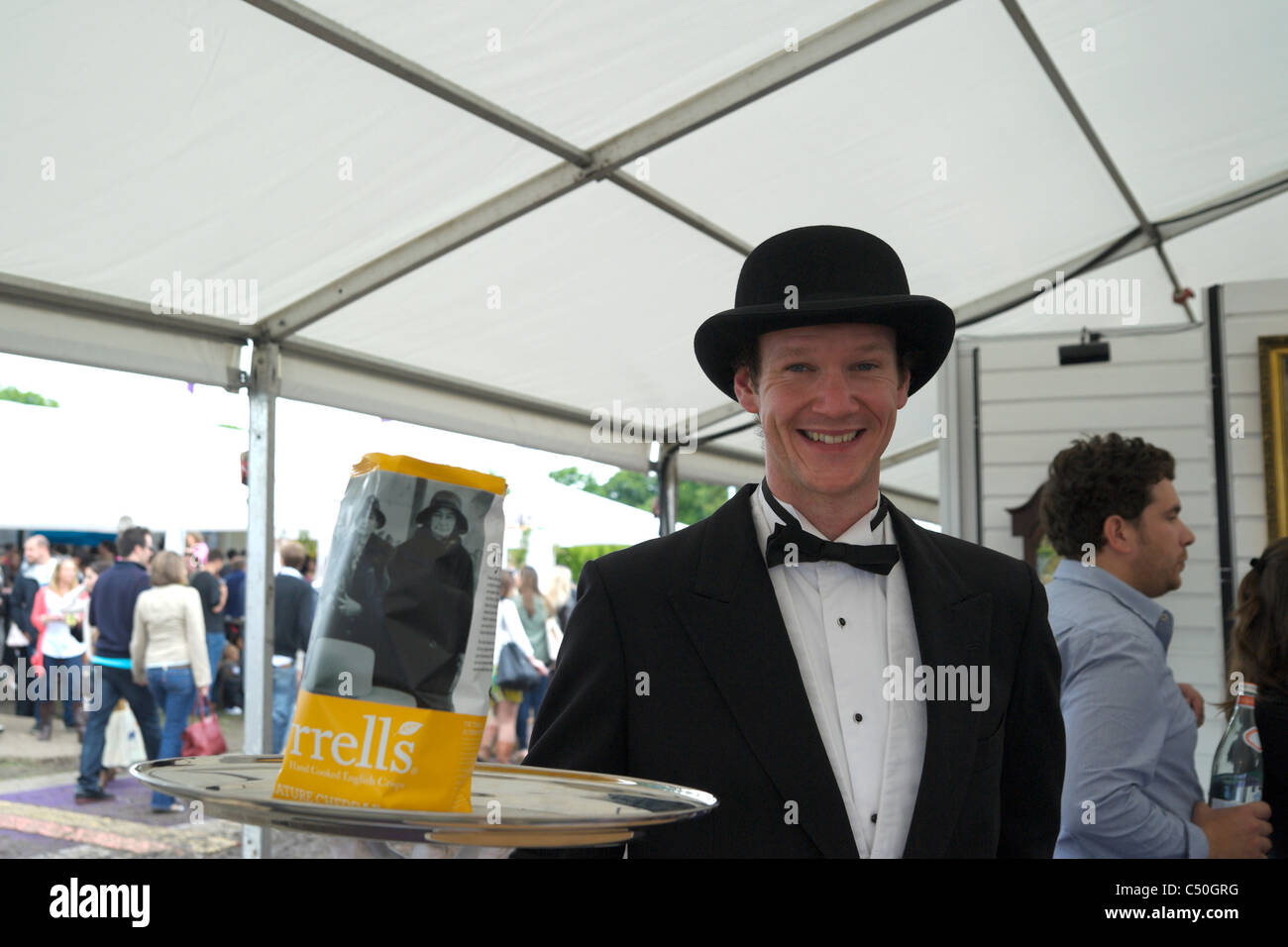 Taste of London exhibition, June 16-19 Regents Park, man dressed as butler, advertising Tyrrel's crisps. Stock Photo