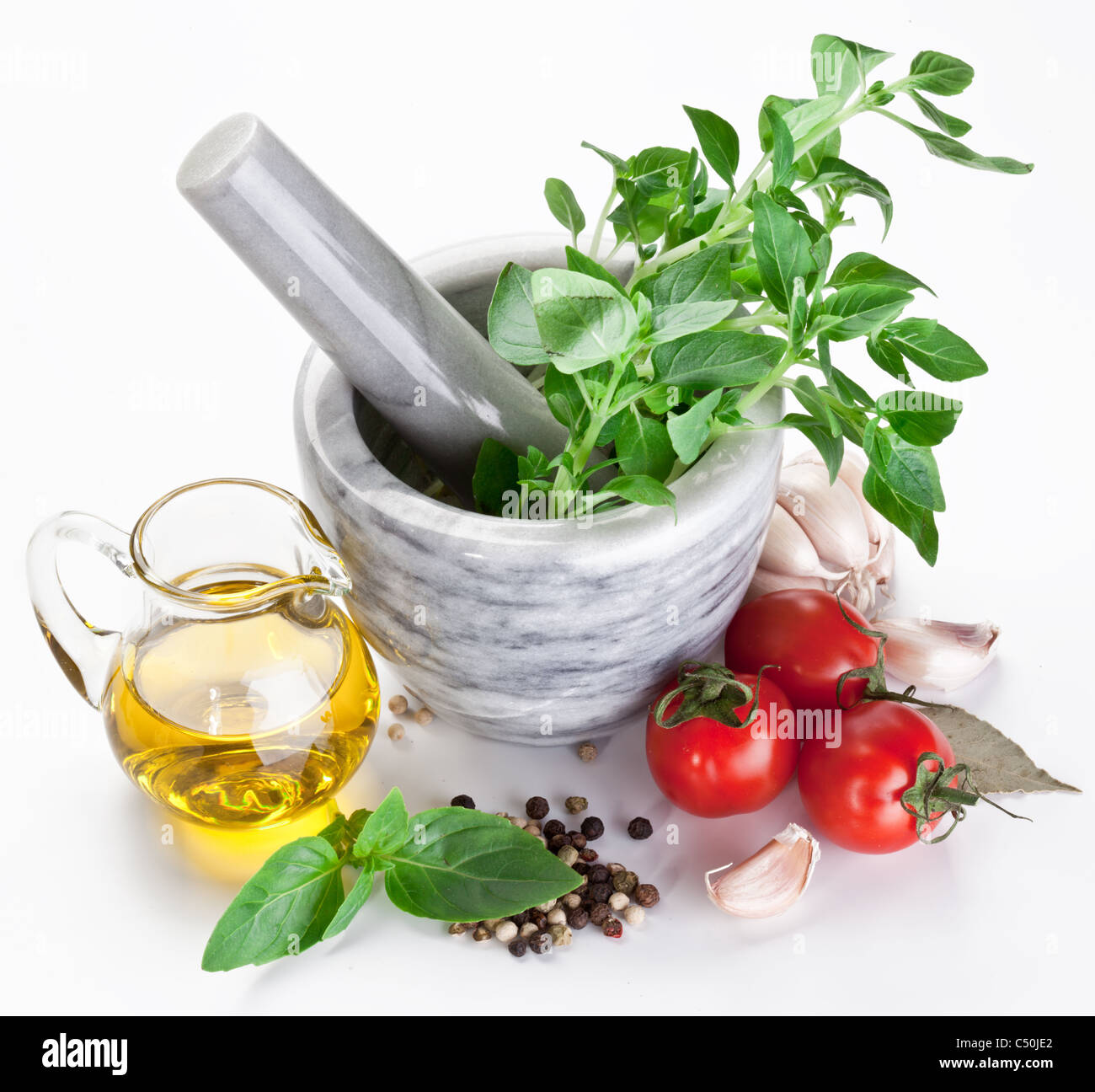 Mortar with pestle and basil herbs and olive oil Stock Photo Alamy