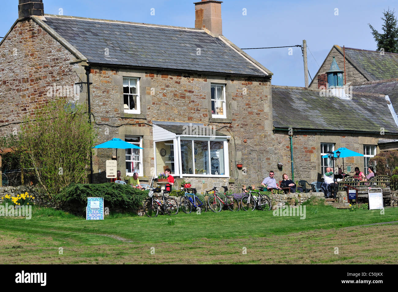 Cyclists and walkers tea shop on village green east of and near Rothbury, Northumberland, UK Stock Photo